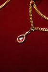 Layered gold-tone chains with red crystal pendant