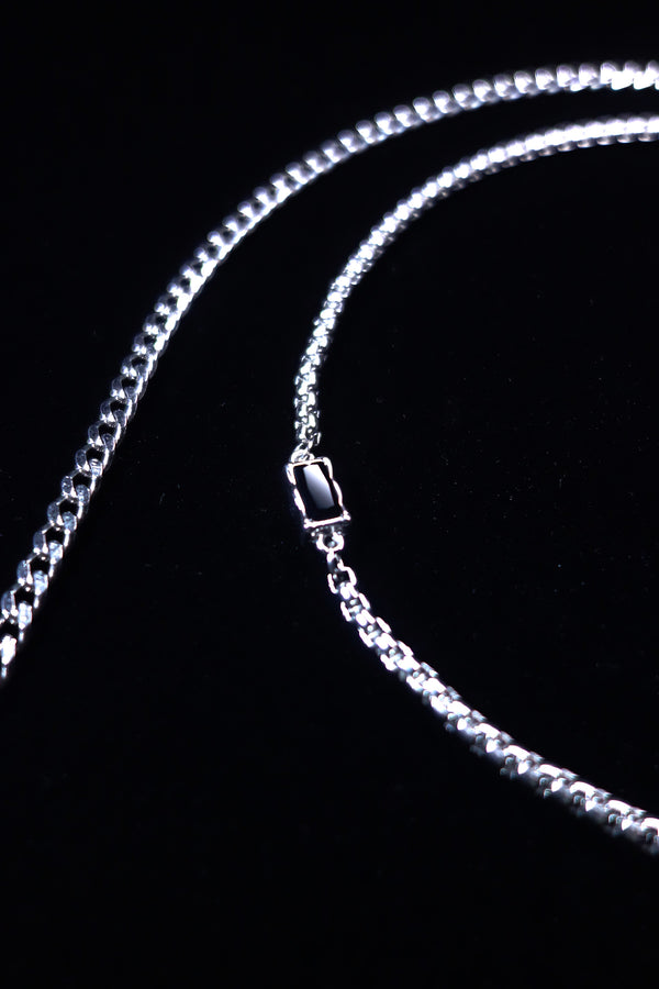 Faceted black crystal accent on close-fitting chain