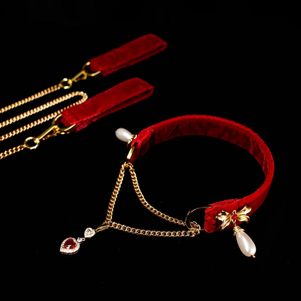 Red choker with gold chain and decorative elements on a black background