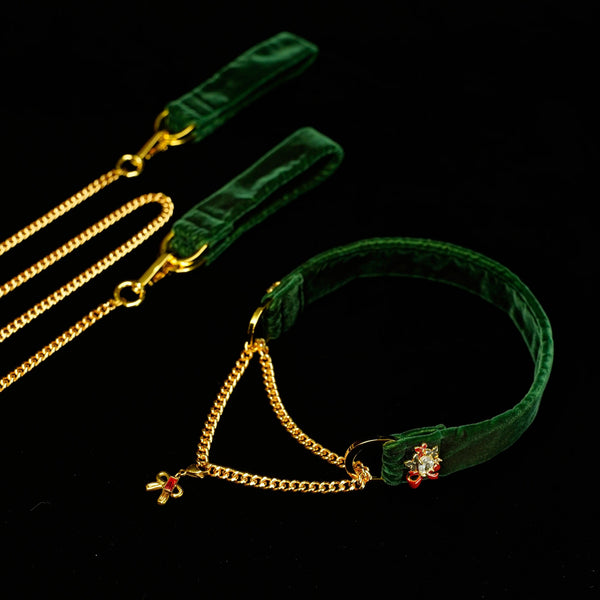 Green velvet belt with gold chain and flower embellishments on a black background