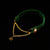 Green velvet headband with gold chain and red gemstones on a black background