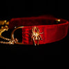 Gold-tone spider and O-ring details on scarlet velvet