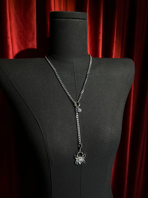 Silver Arachne Silk Slider spider crystal necklace on black display