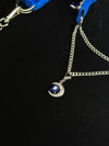 Moon-shaped blue crystal pendant and silver chain detail