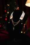 White snowflake choker with star and moon details displayed on a black bust