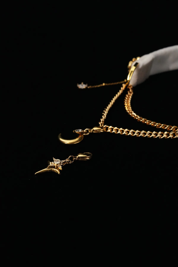 Layered chains and cross-shaped star pendant on the white snowflake choker
