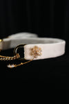 Side view of the white snowflake choker showing the snowflake ornament and fine chain drop