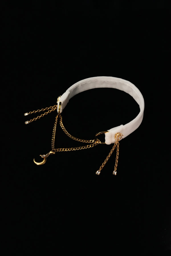 IVORY REVERIE white choker with layered gold-tone chains, a crescent moon and side tassels