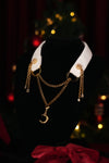 White moon and tassel choker displayed on a black bust
