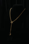SOL & LUNA gold-tone necklace on a black bust with a sun motif and crescent moon drop