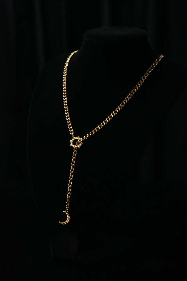 SOL & LUNA gold-tone necklace on a black bust with a sun motif and crescent moon drop