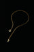 Gold-tone sun and moon necklace laid flat, showing the full chain and end details