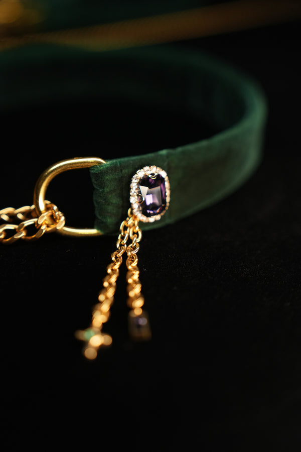 Purple zircon side ornament on forest green velvet