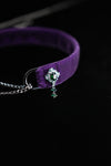 Emerald-inspired side ornament on purple velvet