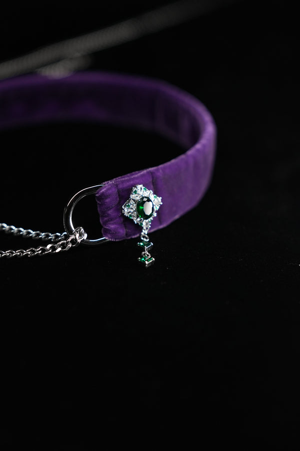 Emerald-inspired side ornament on purple velvet